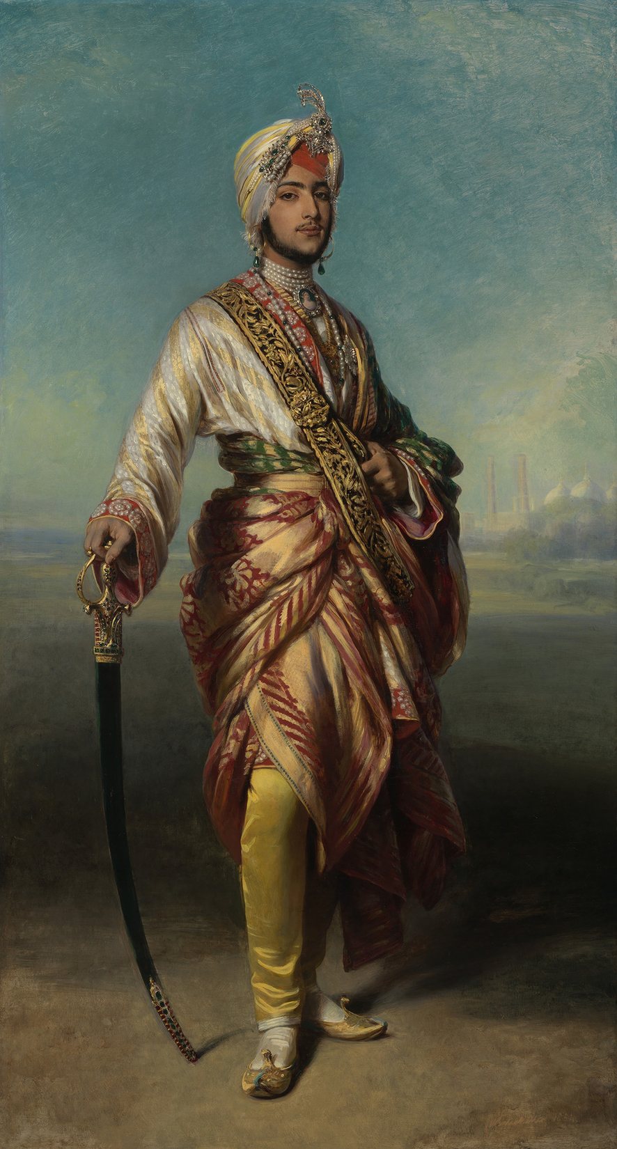 A full-length oil portrait of a slim young man in a white turban with a jewelled aigrette, a long white tunic and red sashes, a sword at his side, against a pale landscape