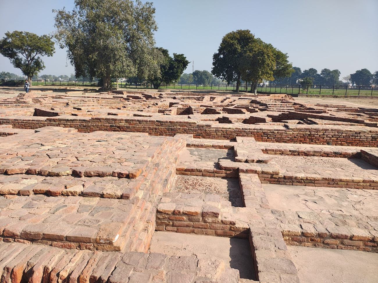 Excavated ancient brickwork under an open sky at the archaeological site of Sanghol, Punjab, India.