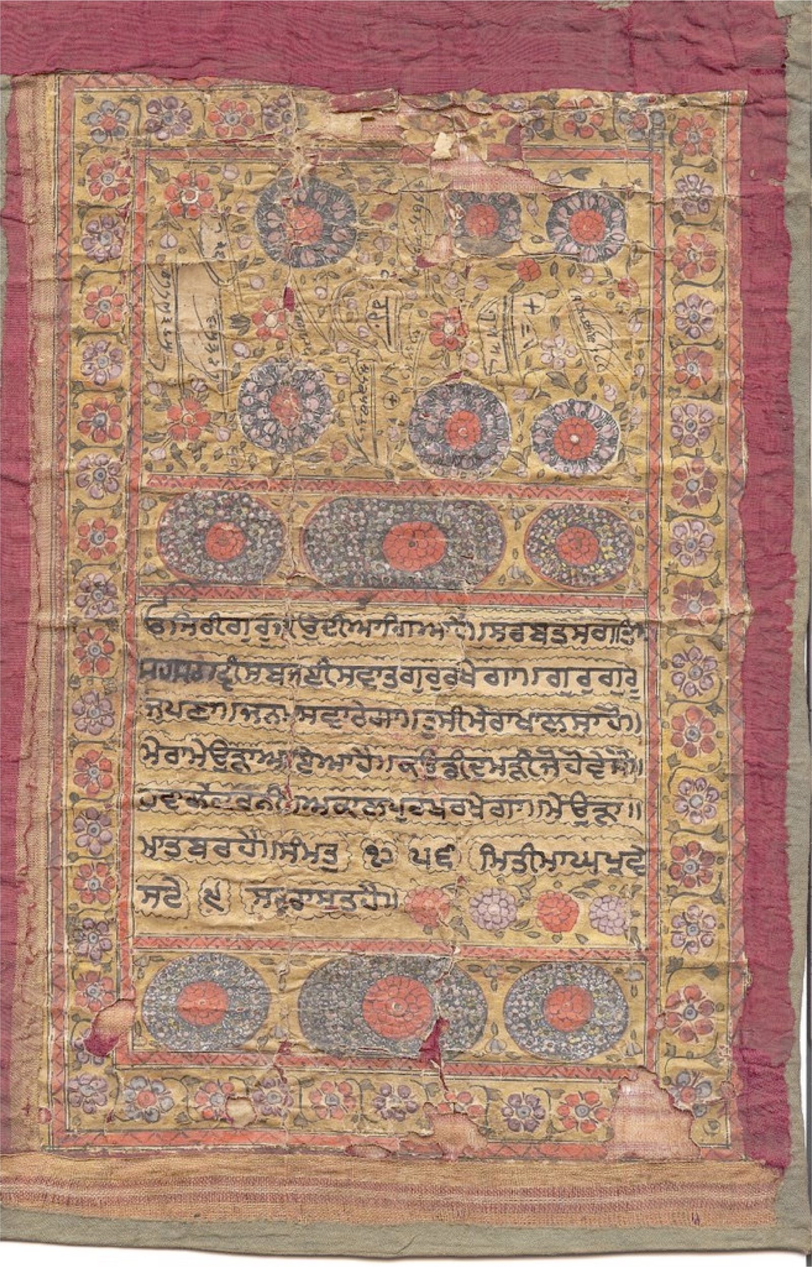A letter on yellowed paper inside painted borders of red and blue flowers, with seven lines of Gurmukhi in a central panel between rows of large illuminated roundels