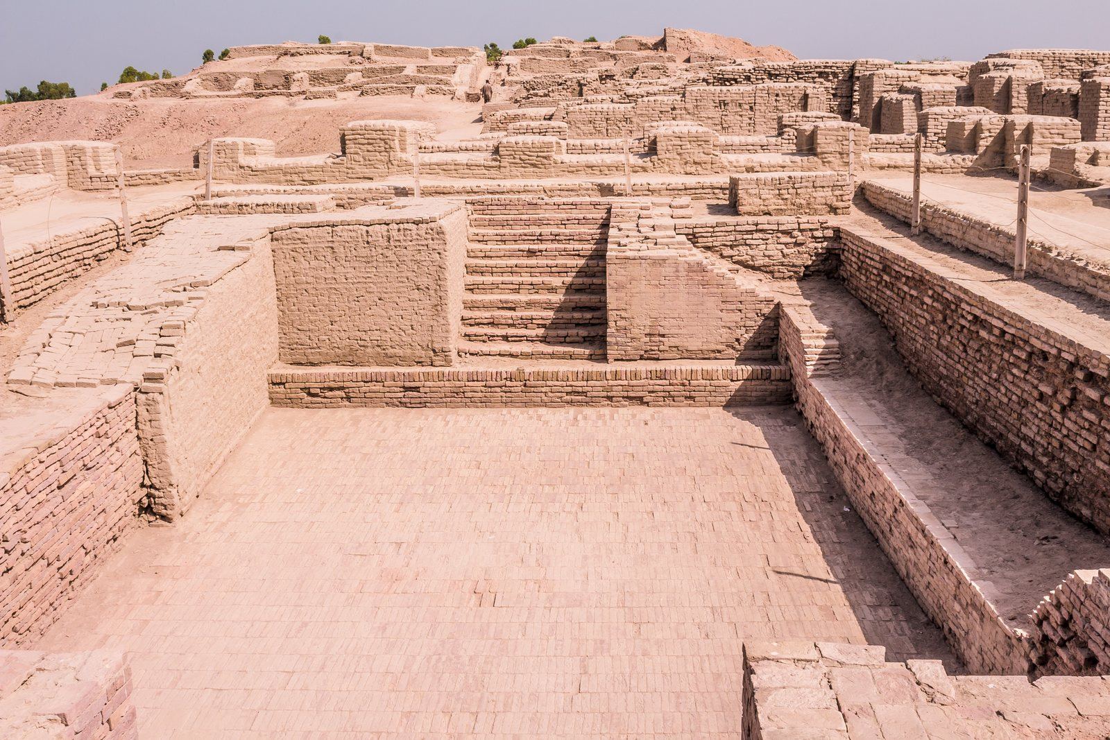 The Great Bath at Mohenjo-daro, a rectangular brick pool with steps down at each end, surrounded by brick walls