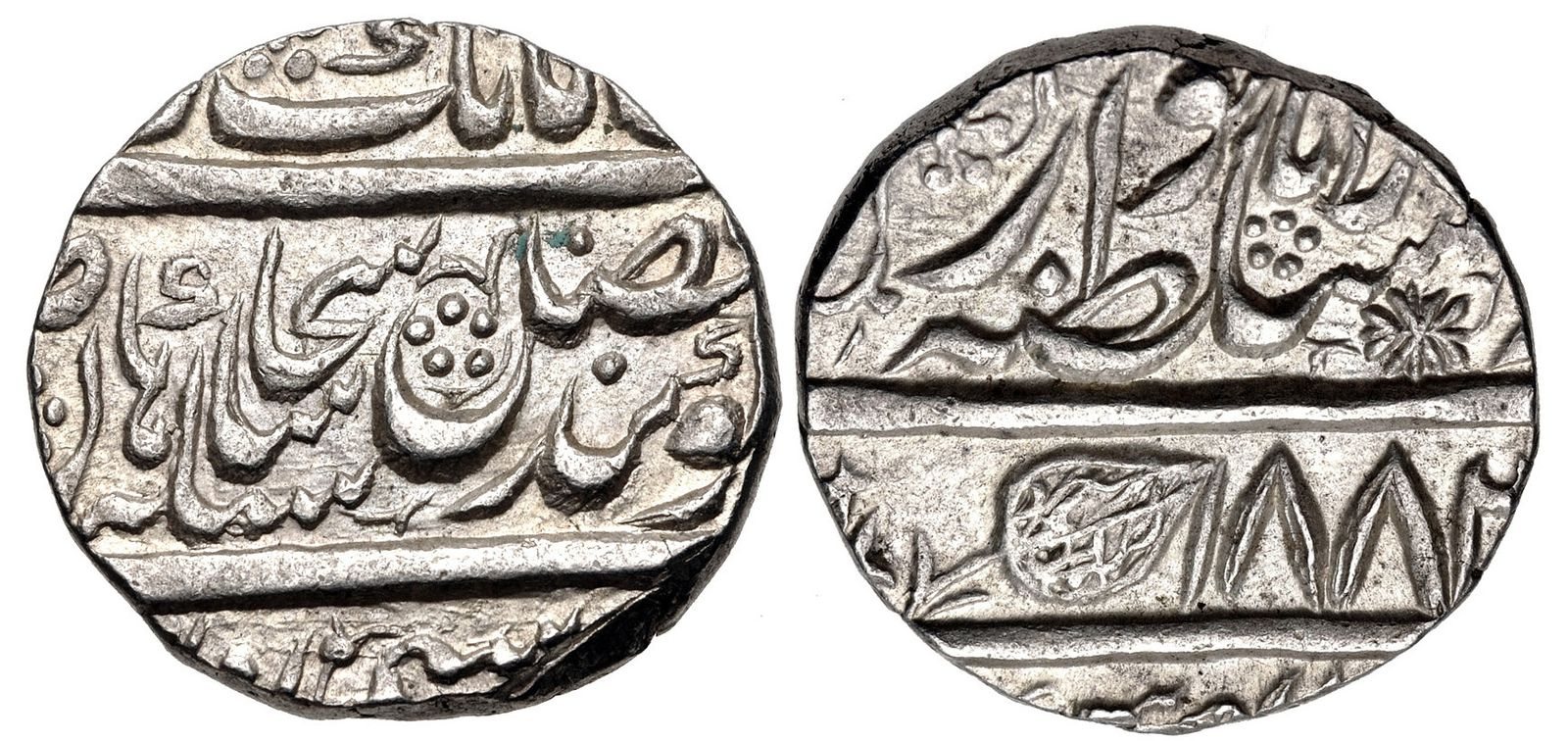 Both faces of a silver rupee of the Sikh Empire, struck at Lahore, with lines of Persian script in relief and a small leaf mark beside the date.