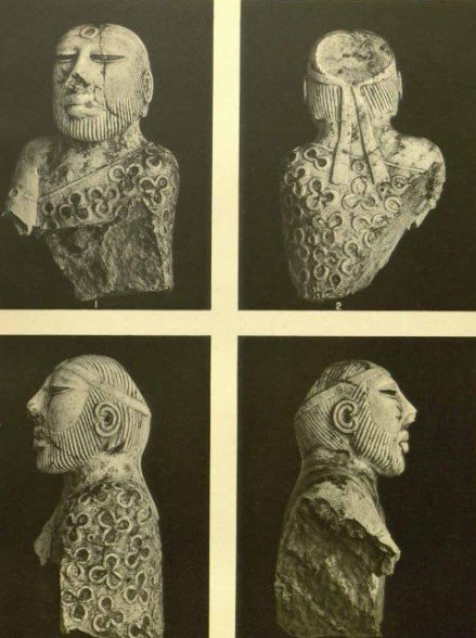 Four black-and-white photographs of a small bearded stone bust, seen from the front, back and both sides, its robe patterned with trefoils