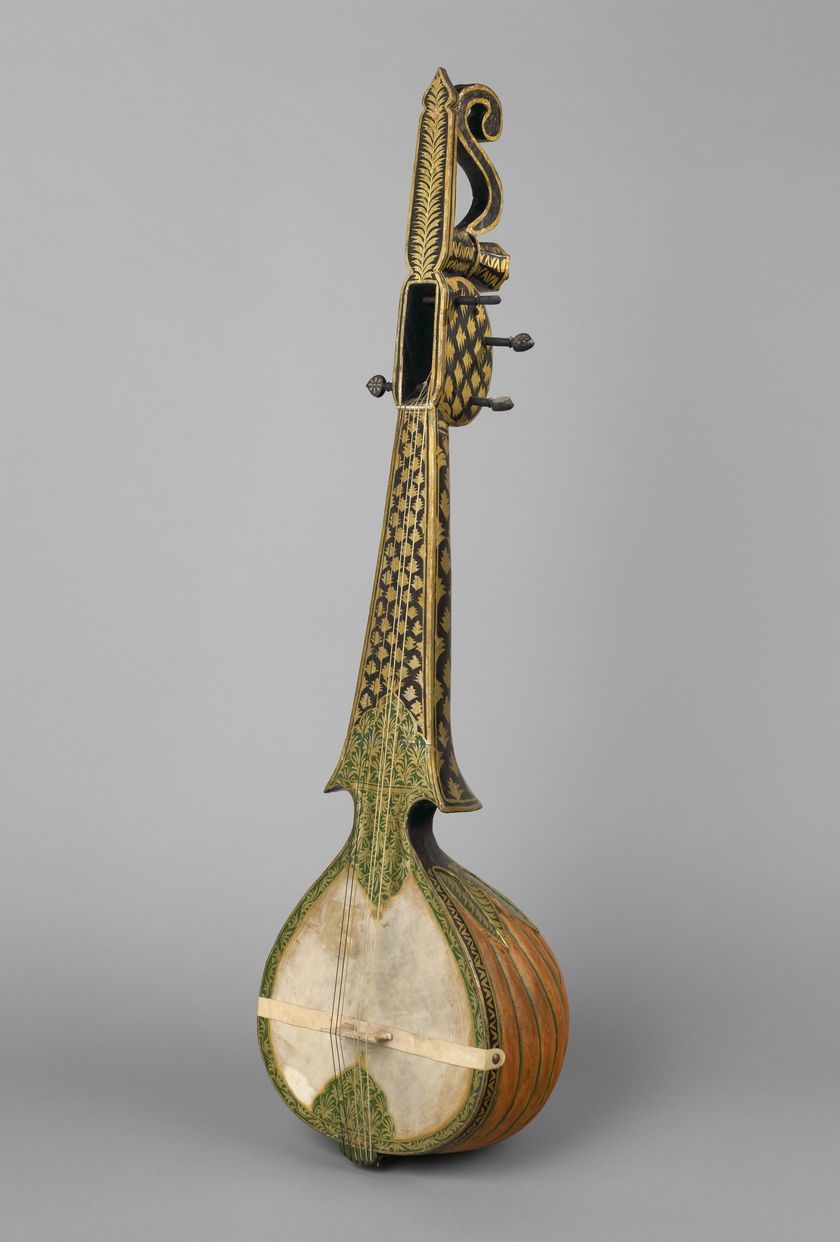 A long-necked plucked lute standing upright, with a round skin-covered belly, a waisted neck and a carved, curling head